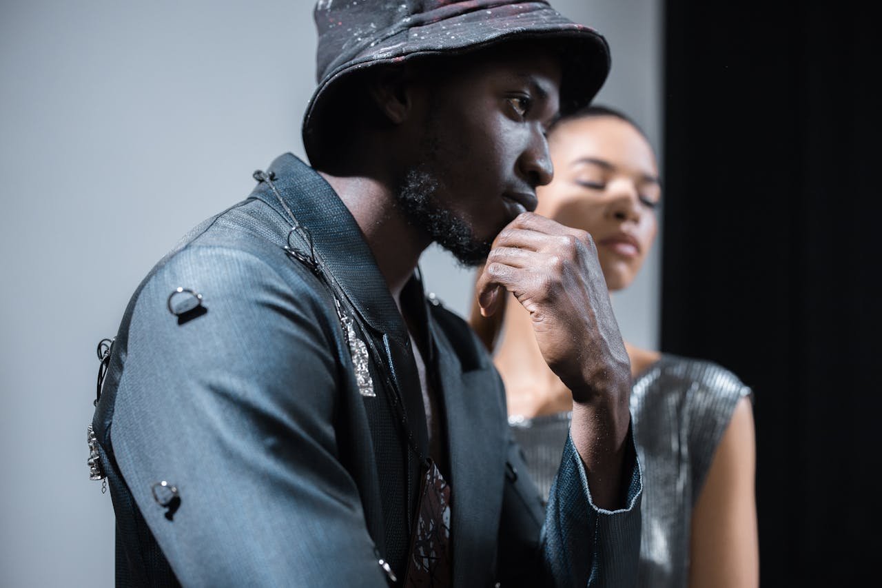 our-mission Stylish African American man posing with thoughtful expression in a studio setting.
