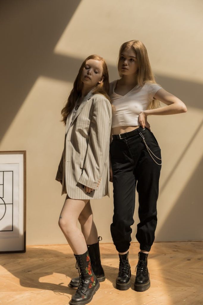 The Art of Drawing Readers In: Your attractive post title goes here Two stylish caucasian women in trendy outfits posing indoors with creative shadows.